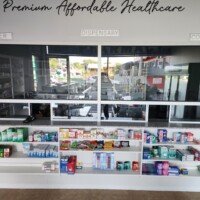 A medical center service counter with labeled sections for "Cashier," "Dispensary," and "Counseling," featuring shelves stocked with various healthcare products.